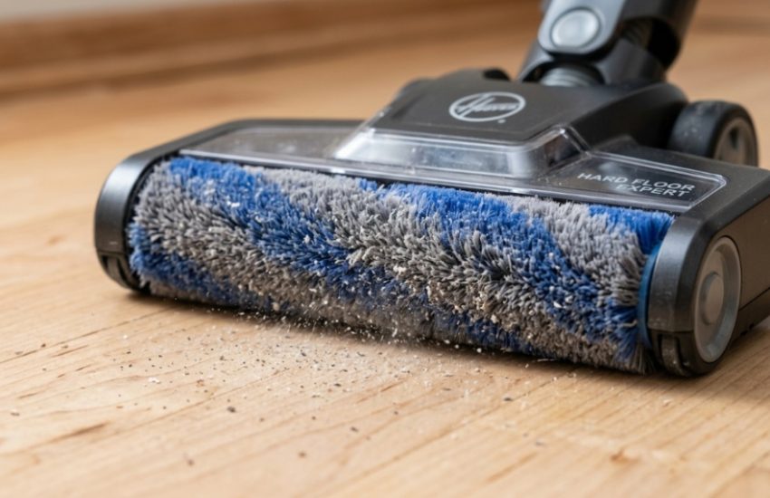 Hoover vacuum cleaner on polished dark oak hardwood floors in a modern living room.