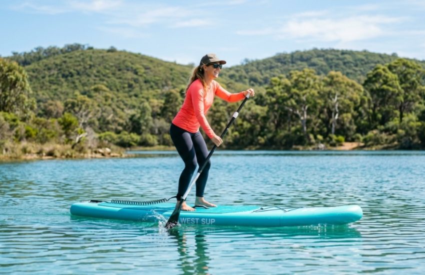 Person paddling an affordable inflatable paddle board on a Western Australia lake.